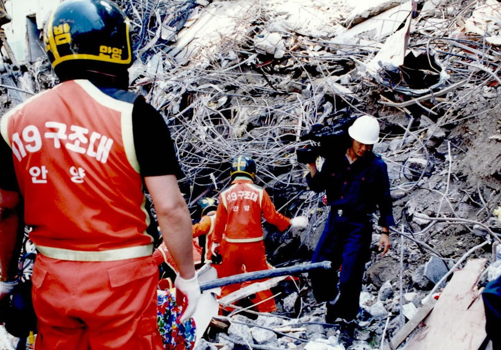 A photo of men at the scene of the Sampoong Department Store Collapse